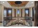 Grand foyer featuring an ornate wrought iron railing, decorative ceiling, and chandelier, offering a luxurious entrance at 3026 Wentworth Way, Tarpon Springs, FL 34688