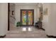 Welcoming foyer with stone floors, a staircase, and double doors with a view of the outdoor landscape at 3026 Wentworth Way, Tarpon Springs, FL 34688