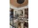 Elegant foyer featuring custom iron railing, coffered ceiling with decorative medallion and views to the living room at 3026 Wentworth Way, Tarpon Springs, FL 34688