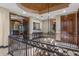 Elegant foyer featuring custom iron railing, coffered ceiling with decorative medallion and views to the living room at 3026 Wentworth Way, Tarpon Springs, FL 34688