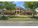 Elegant front exterior features manicured landscaping, stone accents, and a grand entrance at 3026 Wentworth Way, Tarpon Springs, FL 34688