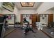 Well-equipped home gym with stationary bikes, a treadmill, and mirrored walls, perfect for an active lifestyle at 3026 Wentworth Way, Tarpon Springs, FL 34688