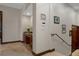 Hallway featuring a built-in desk and staircase with modern railings and neutral-toned walls at 3026 Wentworth Way, Tarpon Springs, FL 34688