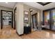 Hallway featuring wood floors, a large mirror, and view into closet and doors leading outside at 3026 Wentworth Way, Tarpon Springs, FL 34688