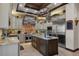 Gourmet kitchen with stainless steel appliances, island, and stone accents at 3026 Wentworth Way, Tarpon Springs, FL 34688