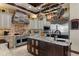 Gourmet kitchen with stone accents, an island, and stainless steel appliances at 3026 Wentworth Way, Tarpon Springs, FL 34688