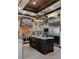 Gourmet kitchen with stainless steel appliances, island, and stone accents at 3026 Wentworth Way, Tarpon Springs, FL 34688