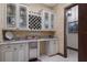 A well-appointed kitchenette features custom cabinets, a wine rack, and a convenient beverage refrigerator at 3026 Wentworth Way, Tarpon Springs, FL 34688