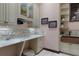 Stylish laundry room with stone counters, copper sink, and custom cabinetry at 3026 Wentworth Way, Tarpon Springs, FL 34688