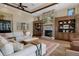 Inviting living room features a stone fireplace and custom built-in shelving on either side at 3026 Wentworth Way, Tarpon Springs, FL 34688