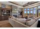 Sun-filled living room boasts large windows, hardwood floors, and stone fireplace at 3026 Wentworth Way, Tarpon Springs, FL 34688