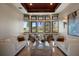 Elegant living room with large windows showcasing outdoor views, accentuated by modern decor and marble floors at 3026 Wentworth Way, Tarpon Springs, FL 34688