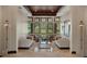 Spacious living room with floor-to-ceiling windows offering a view of the outdoors, featuring neutral tones and marble floors at 3026 Wentworth Way, Tarpon Springs, FL 34688