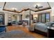 Spacious primary bedroom boasts a cozy fireplace, hardwood floors, and a coffered ceiling with fan at 3026 Wentworth Way, Tarpon Springs, FL 34688