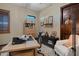 Stylish home office featuring a wooden desk, neutral walls, modern decor, and a comfortable white accent chair at 3026 Wentworth Way, Tarpon Springs, FL 34688