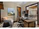 Bright home office with a wooden desk, comfortable seating, and views through an arched doorway, creating a productive workspace at 3026 Wentworth Way, Tarpon Springs, FL 34688