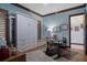 Home office showcasing a unique Murphy bed, natural light from shuttered window, and a warm, inviting ambiance at 3026 Wentworth Way, Tarpon Springs, FL 34688