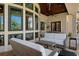 Covered patio featuring an outdoor seating area, a television, a ceiling fan, and view of the backyard at 3026 Wentworth Way, Tarpon Springs, FL 34688