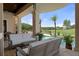 Covered patio with comfortable seating and a serene view of the pool, landscape, and neighborhood at 3026 Wentworth Way, Tarpon Springs, FL 34688