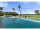 Backyard oasis with pool, landscaped yard, privacy fence, and clear views of the tree-lined property at 3026 Wentworth Way, Tarpon Springs, FL 34688