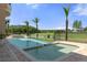 Sparkling pool features a spa, fence surround, and views of the manicured backyard and mature trees at 3026 Wentworth Way, Tarpon Springs, FL 34688