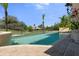 Beautiful pool with stone deck and decorative water feature overlooking a large grassy lawn at 3026 Wentworth Way, Tarpon Springs, FL 34688
