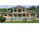 Beautiful home exterior with a pool, spa, and manicured landscaping that is designed for elegant outdoor living at 3026 Wentworth Way, Tarpon Springs, FL 34688