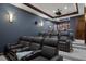 Home theater with comfortable recliner seating, projector, and built-in surround sound system at 3026 Wentworth Way, Tarpon Springs, FL 34688