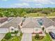 A high angle view of this beautiful home featuring a large backyard, a screen enclosed pool, and well manicured lawn at 305 Royal Palm Way, Spring Hill, FL 34608
