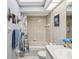 Bright bathroom featuring updated fixtures, a shower/tub combo, neutral tile and attractive lighting at 305 Royal Palm Way, Spring Hill, FL 34608