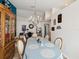 Spacious dining room featuring wood floors, chandelier, and a decorative cabinet, perfect for Gathering gatherings at 305 Royal Palm Way, Spring Hill, FL 34608