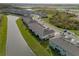 This scenic aerial view captures serene townhouses next to a waterway, complete with well-maintained lawns at 31718 Blue Passing Loop, Wesley Chapel, FL 33545