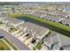 Beautiful aerial view of townhouses bordering a waterway, surrounded by lush landscaping and residences at 31718 Blue Passing Loop, Wesley Chapel, FL 33545