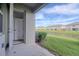 A private outdoor patio features lush landscaping and views of the beautiful pond at 31718 Blue Passing Loop, Wesley Chapel, FL 33545