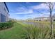 A private backyard with lush landscaping and pond provides a serene and relaxing outdoor space at 31718 Blue Passing Loop, Wesley Chapel, FL 33545