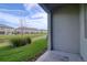 A private backyard features lush landscaping and views of the beautiful pond at 31718 Blue Passing Loop, Wesley Chapel, FL 33545
