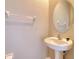 Half bathroom featuring pedestal sink, toilet, and towel rack at 31718 Blue Passing Loop, Wesley Chapel, FL 33545