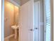 Half bathroom featuring pedestal sink, toilet, and view of the window at 31718 Blue Passing Loop, Wesley Chapel, FL 33545