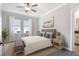 Comfortable bedroom featuring a ceiling fan, natural light, and neutral decor at 31718 Blue Passing Loop, Wesley Chapel, FL 33545