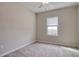 A bright bedroom features a neutral color scheme, ceiling fan, and a window for natural light at 31718 Blue Passing Loop, Wesley Chapel, FL 33545