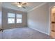Bright bedroom with carpeted floors, neutral walls, and natural light from two windows at 31718 Blue Passing Loop, Wesley Chapel, FL 33545
