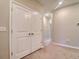 Double-door closet with carpeted floor and neutral walls at 31718 Blue Passing Loop, Wesley Chapel, FL 33545