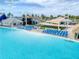 Relaxing beachside chairs on an expansive blue lagoon featuring a stage, picnic area, and cabanas at 31718 Blue Passing Loop, Wesley Chapel, FL 33545
