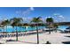 Stunning community pool area featuring lounge chairs, palm trees and white sand beach, ideal for relaxation at 31718 Blue Passing Loop, Wesley Chapel, FL 33545