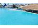 Relaxing beachside cabana on an expansive blue lagoon featuring a swim-up bar and a lounge area at 31718 Blue Passing Loop, Wesley Chapel, FL 33545