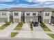 Attractive townhome with two stories, a neutral color palette, and manicured landscaping at 31718 Blue Passing Loop, Wesley Chapel, FL 33545