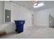 A two car garage with concrete flooring, white walls, and plenty of storage space at 31718 Blue Passing Loop, Wesley Chapel, FL 33545