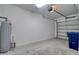 A two car garage features concrete flooring, white walls, and plenty of storage space at 31718 Blue Passing Loop, Wesley Chapel, FL 33545