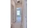 Hallway view into bedroom with ceiling fan and window at 31718 Blue Passing Loop, Wesley Chapel, FL 33545