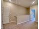 Upper hallway with carpeting and views to bedrooms and bathroom at 31718 Blue Passing Loop, Wesley Chapel, FL 33545